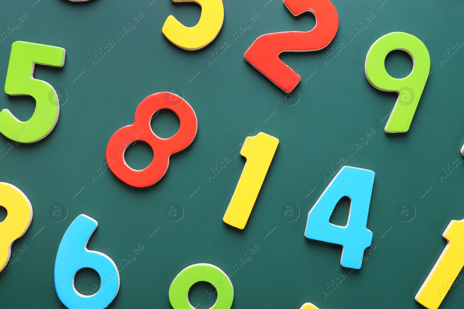 Photo of Colorful numbers on green background, flat lay