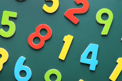 Photo of Colorful numbers on green background, flat lay