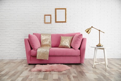 Modern living room interior with stylish pink sofa