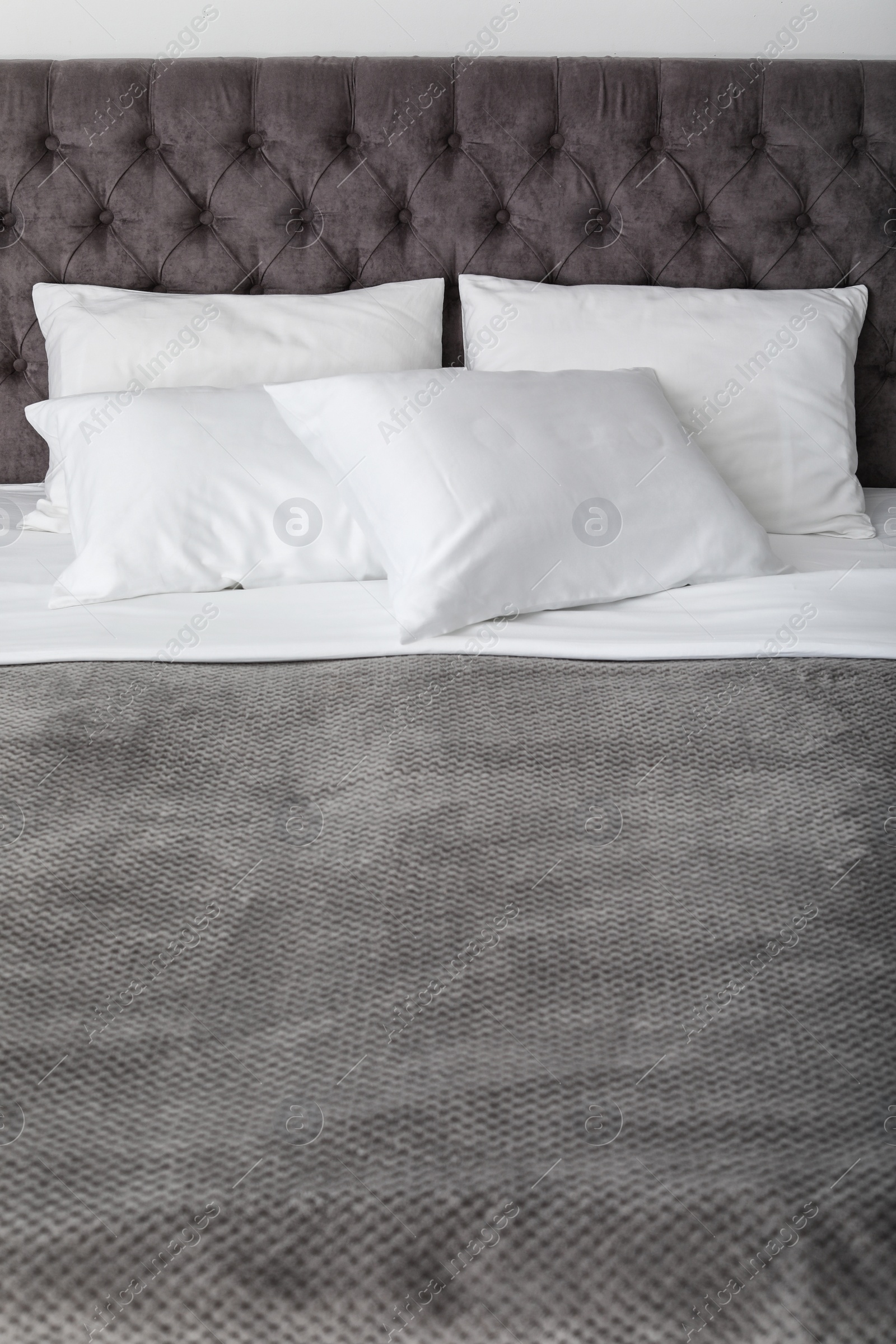 Photo of Soft white pillows on comfortable bed, closeup