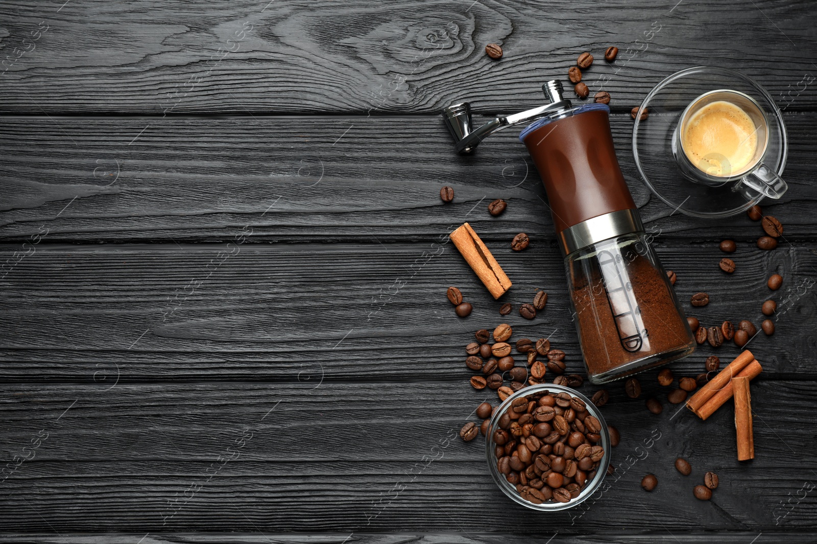 Photo of Manual coffee grinder with powder and beans on wooden table, flat lay. Space for text