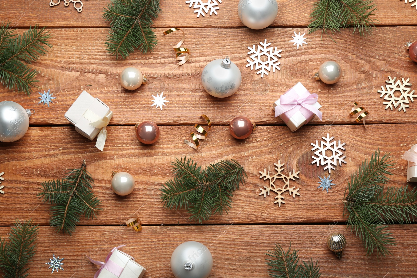 Photo of Flat lay composition with Christmas decorations on wooden background. Winter season