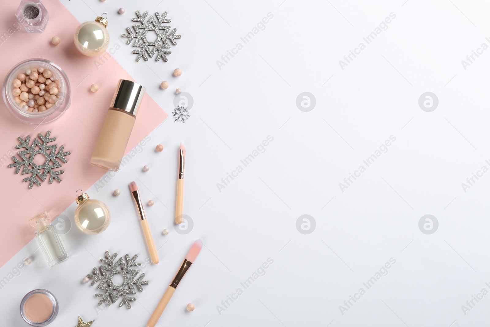 Photo of Flat lay composition with decorative cosmetic products on color background, space for text. Winter care