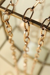 Stand with different metal chains, closeup. Luxury jewelry