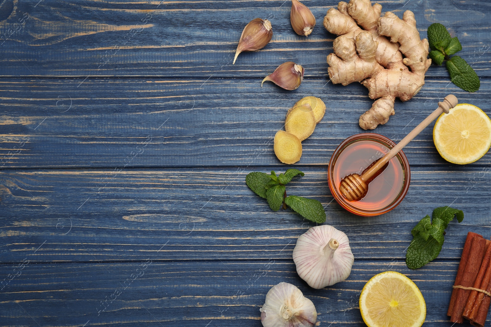 Photo of Flat lay composition with fresh products on blue wooden table, space for text. Natural antibiotics