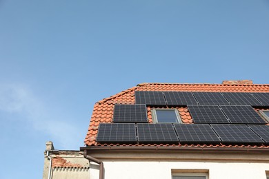 Photo of House with installed solar panels on roof, space for text. Alternative energy