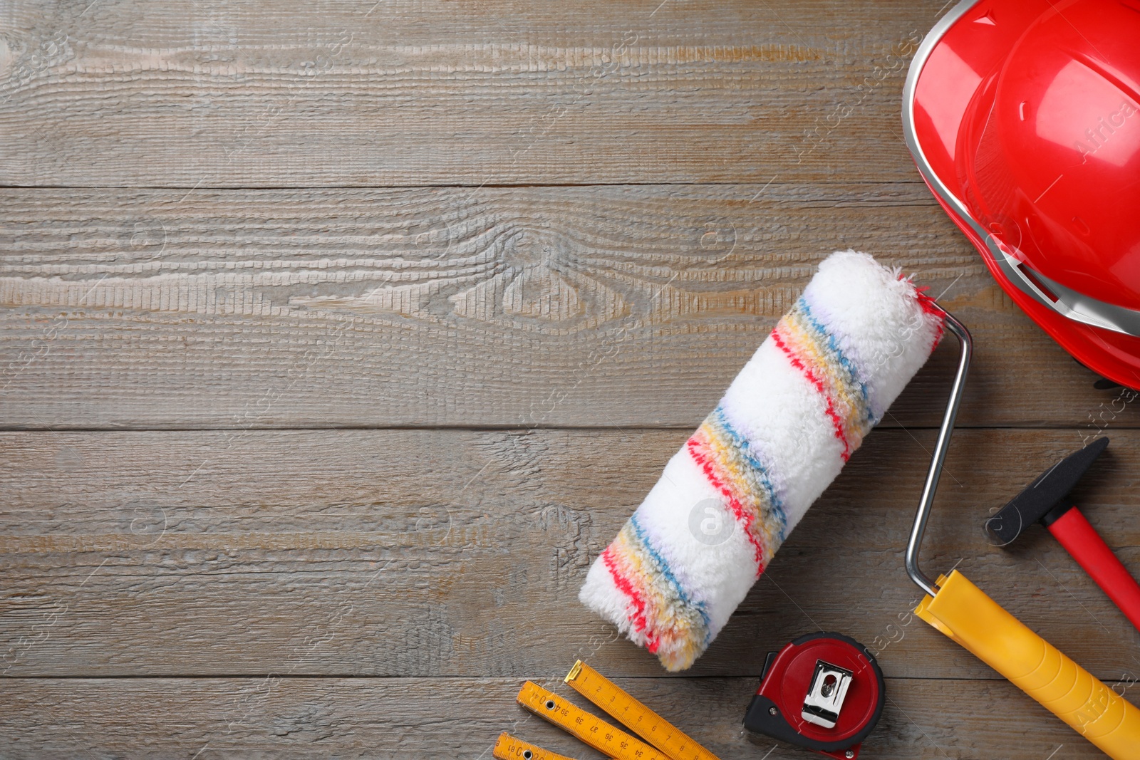 Photo of Flat lay composition with different construction tools on wooden background. Space for text