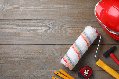 Photo of Flat lay composition with different construction tools on wooden background. Space for text