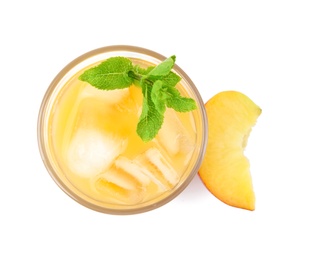 Photo of Delicious refreshing peach cocktail in glass and fresh fruit on white background, top view