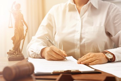 Image of Lawyer working with document at table in office, closeup