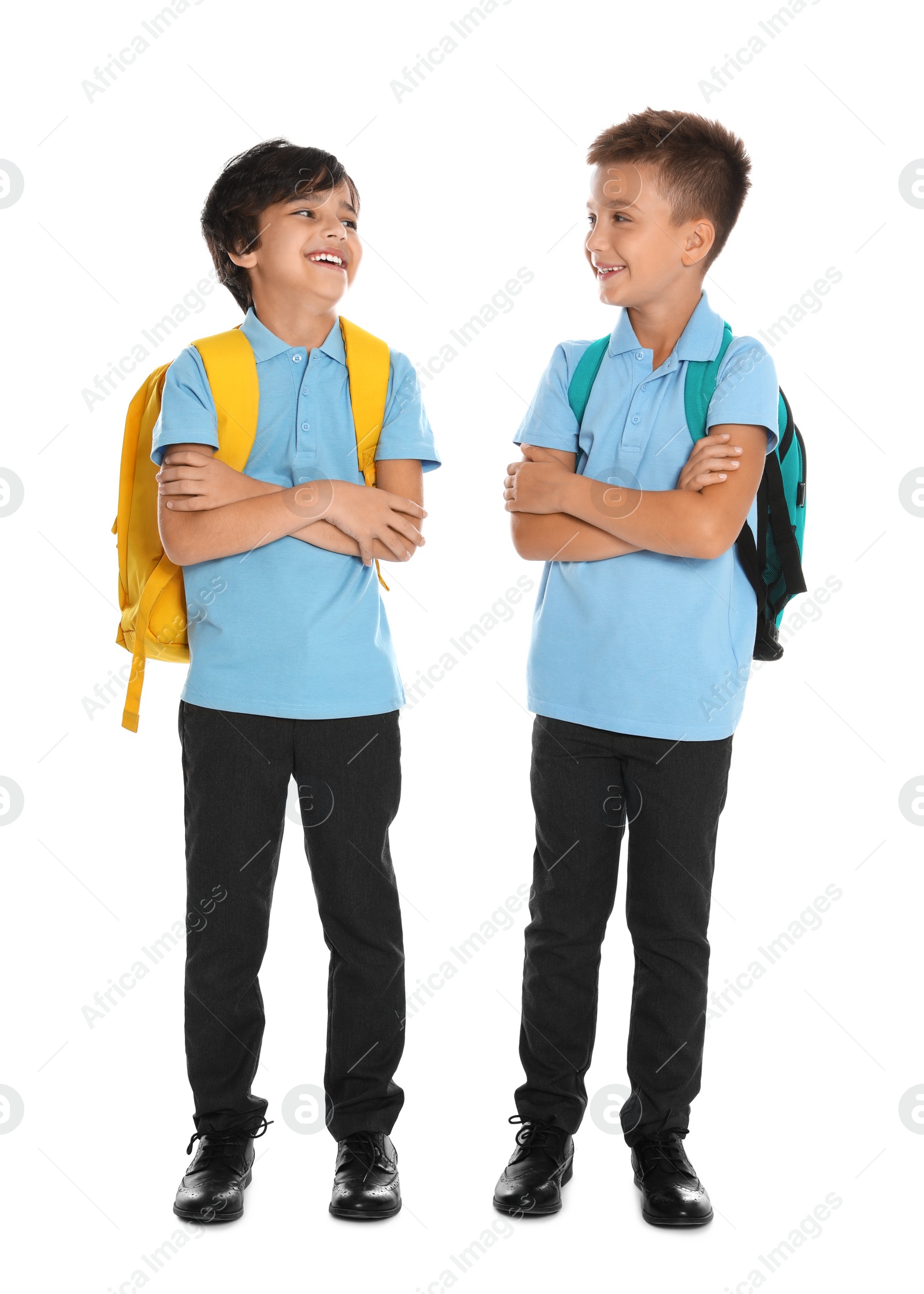 Photo of Happy boys in school uniform on white background