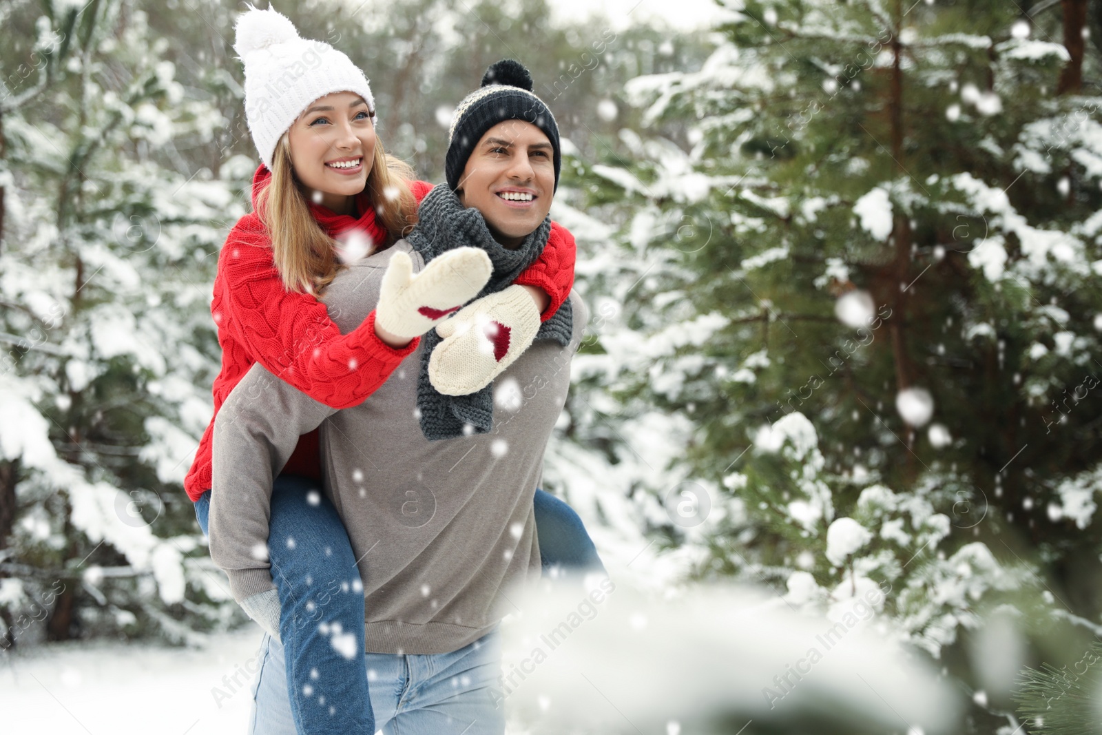 Photo of Beautiful happy couple in snowy forest on winter day