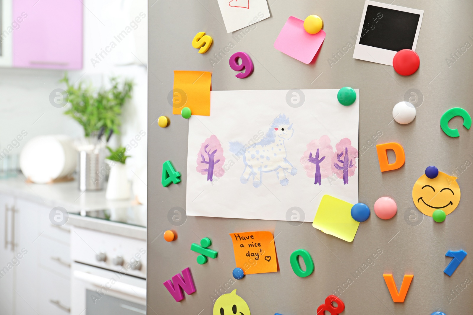 Photo of Sheets of paper, child's drawing and magnets on refrigerator door in kitchen. Space for text