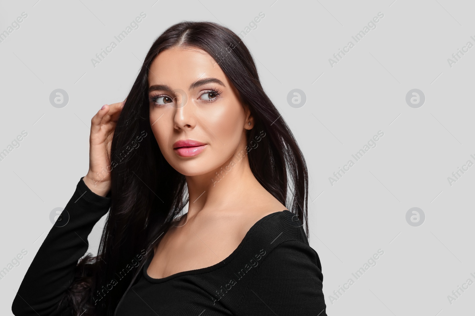 Photo of Portrait of beautiful young woman on light grey background