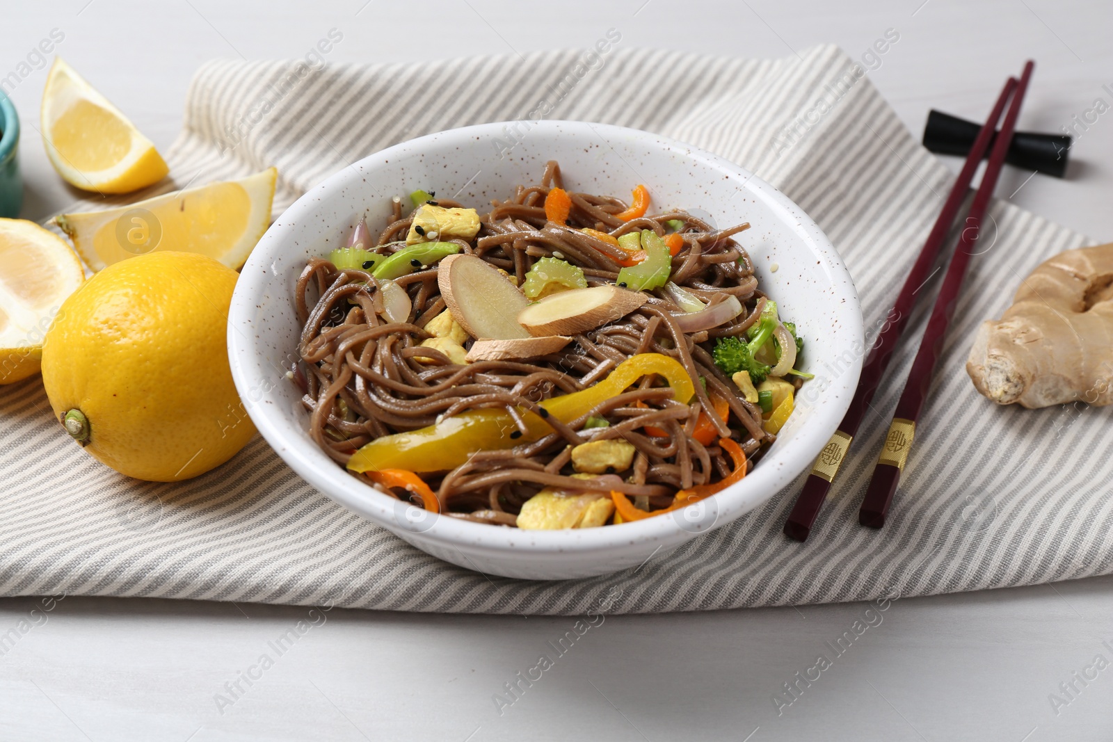 Photo of Stir-fry. Delicious cooked noodles with chicken and vegetables in bowl served on table