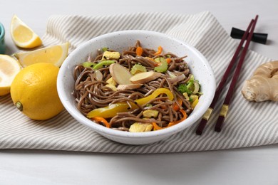 Photo of Stir-fry. Delicious cooked noodles with chicken and vegetables in bowl served on table