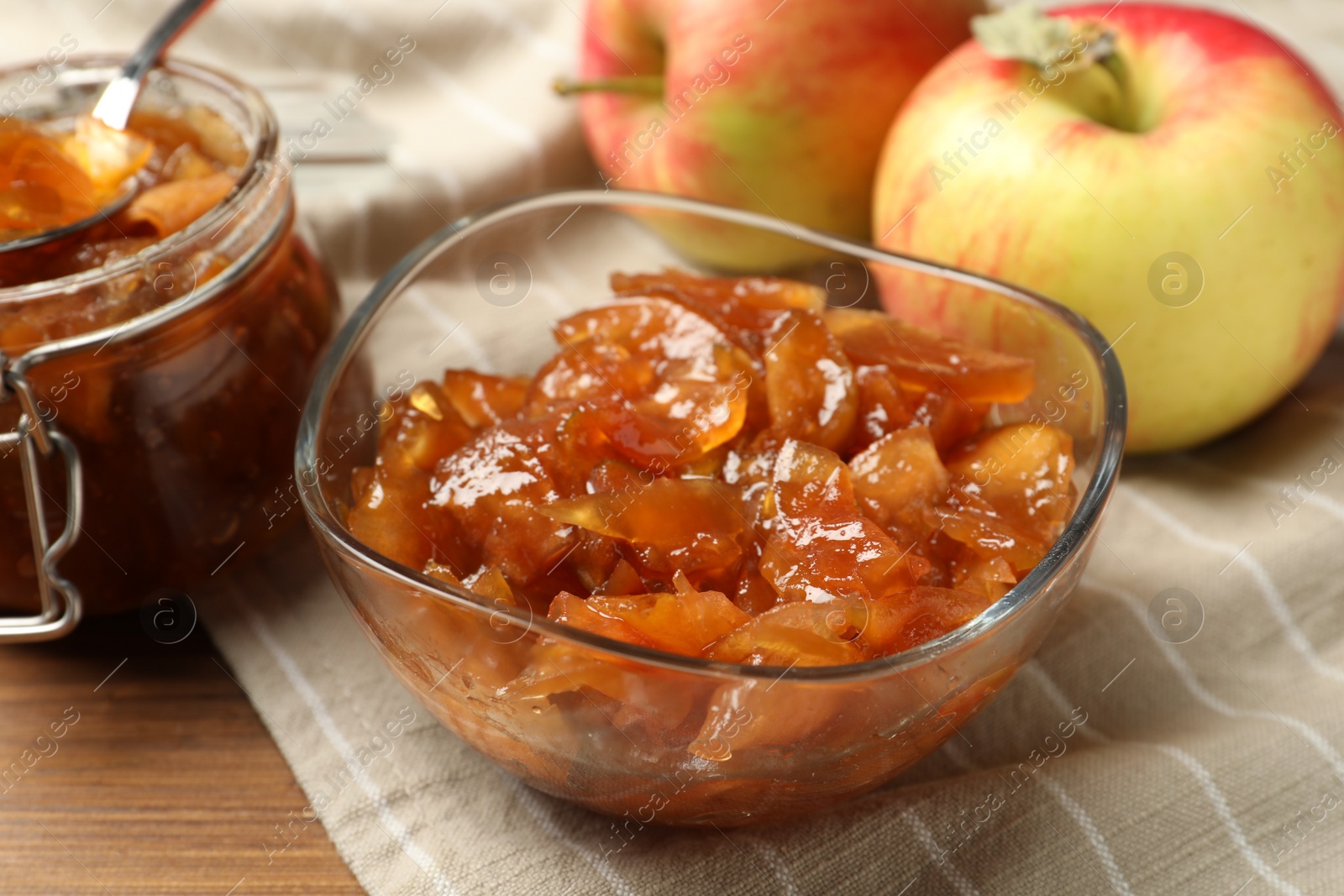Photo of Tasty apple jam and fresh fruits on wooden table, closeup
