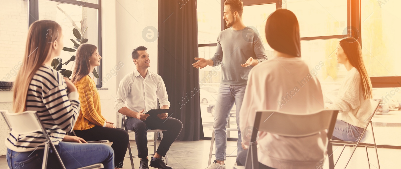 Image of Psychotherapist working with patients in group therapy session indoors. Banner design