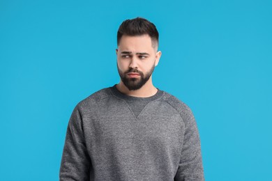 Photo of Portrait of sad man on light blue background