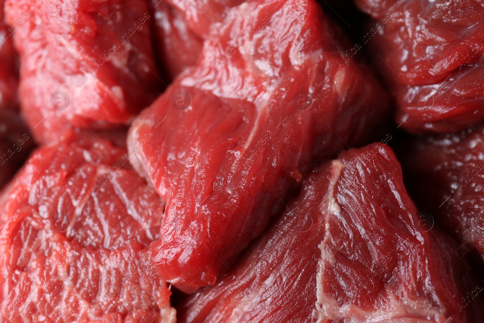 Photo of Pieces of raw beef meat as background, closeup