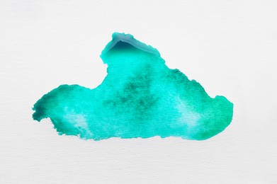 Photo of Blot of turquoise ink on white background, top view