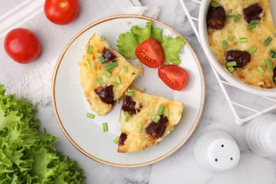 Photo of Tasty sausage casserole with green onions and vegetables served on white marble table, flat lay