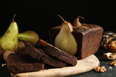 Photo of Tasty pear bread on black table. Homemade cake