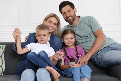 Photo of Portrait of happy family with children on sofa at home