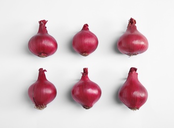 Beautiful composition with ripe red onions on white background