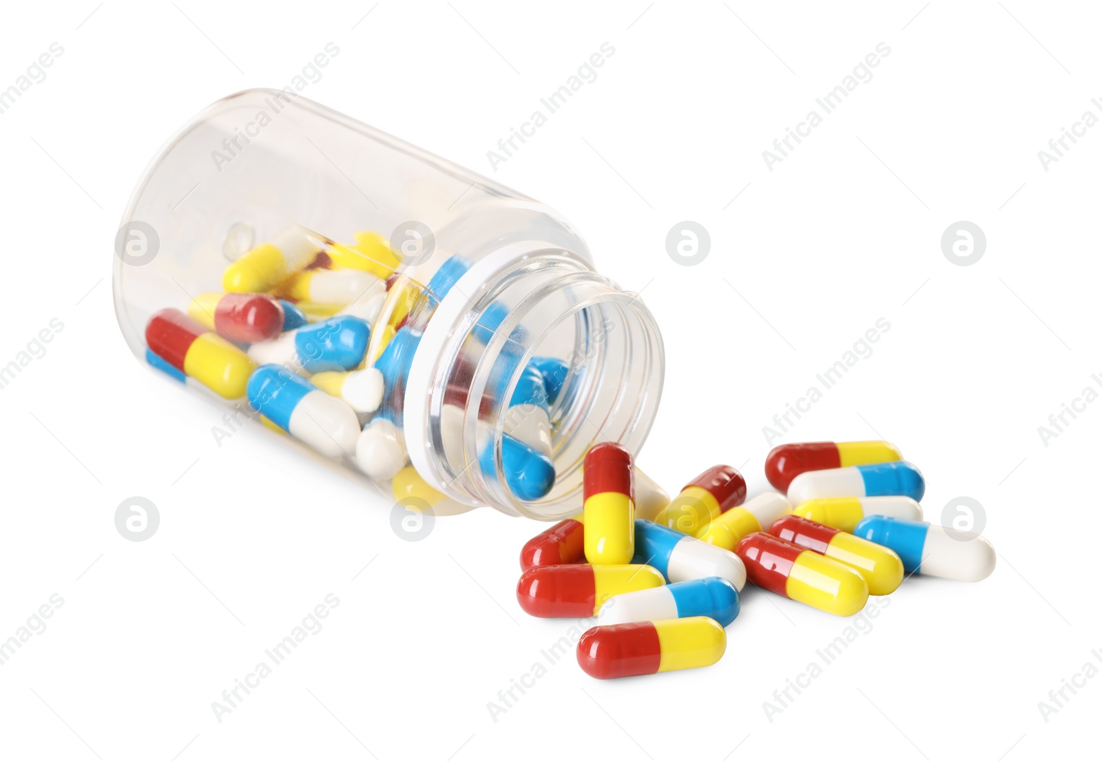 Photo of Scattered antibiotic pills and bottle isolated on white