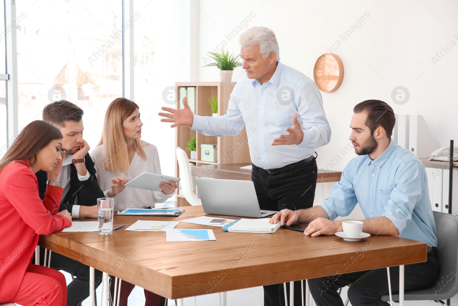 Photo of Office employees having argument during business meeting