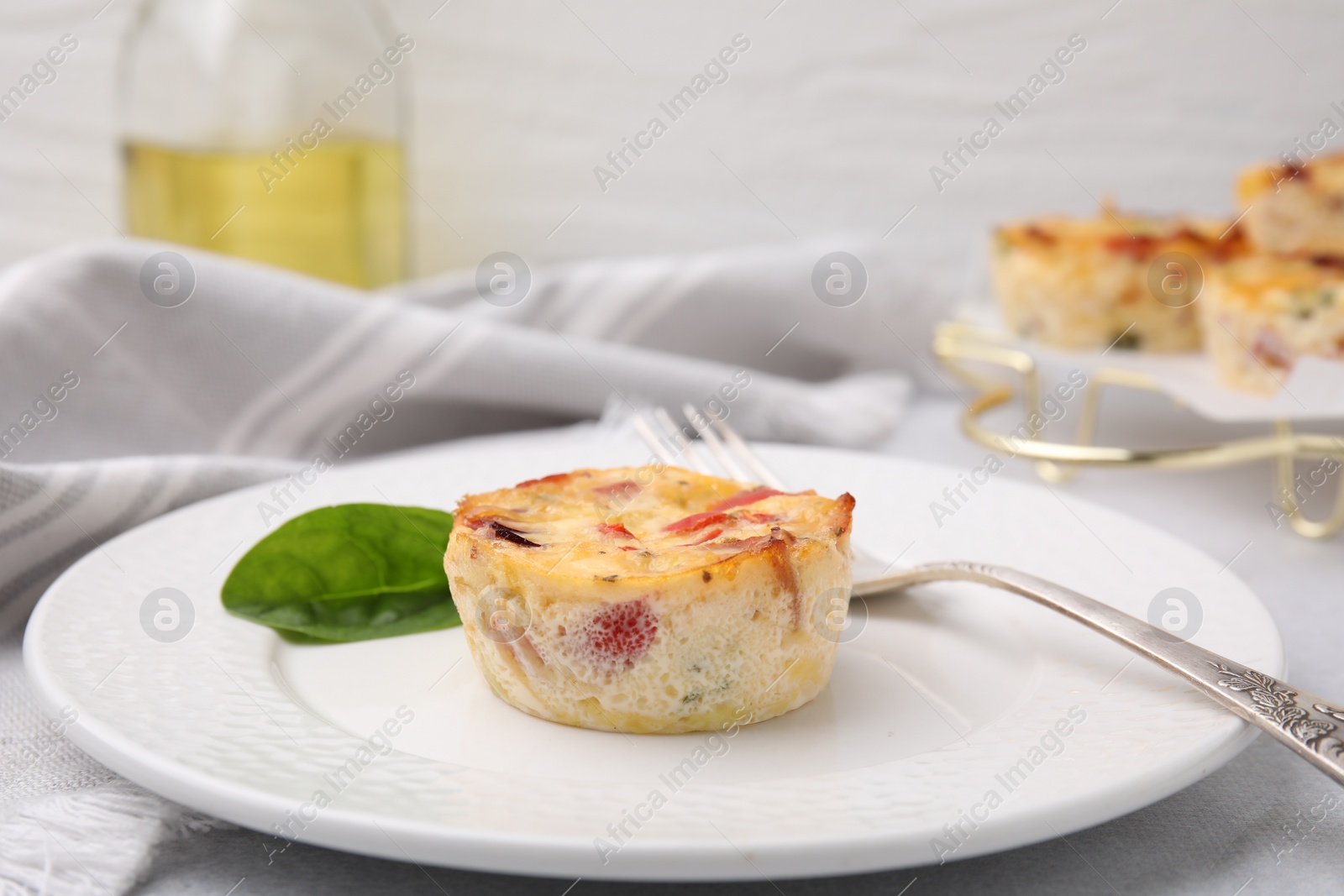 Photo of Freshly baked bacon and egg muffin with cheese served on table, closeup. Space for text