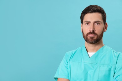 Photo of Nurse in medical uniform on light blue background, space for text