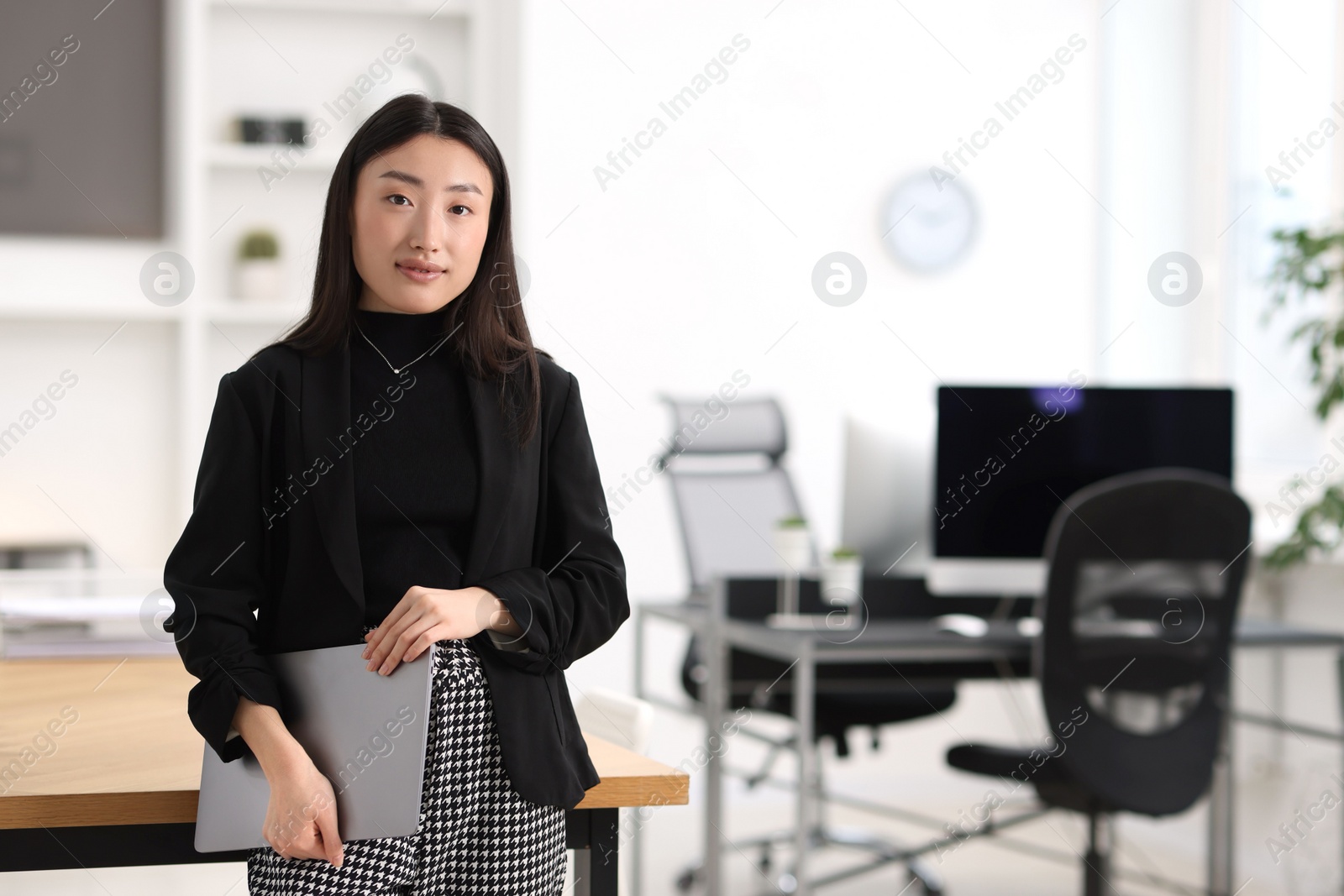 Photo of Portrait of beautiful businesswoman with laptop in office. Space for text