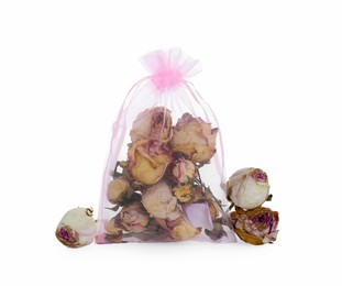 Scented sachet and dried rose flowers on white background