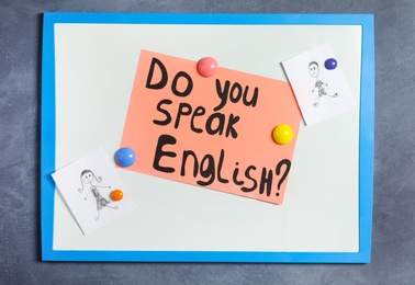 Photo of Board with question Do You Speak English on grey background, top view