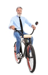 Portrait of handsome mature man with bicycle on white background