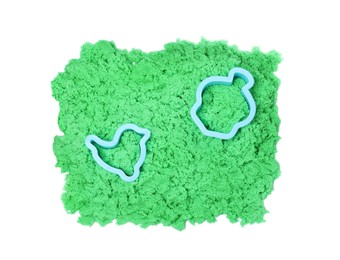 Green kinetic sand and toys on white background, top view