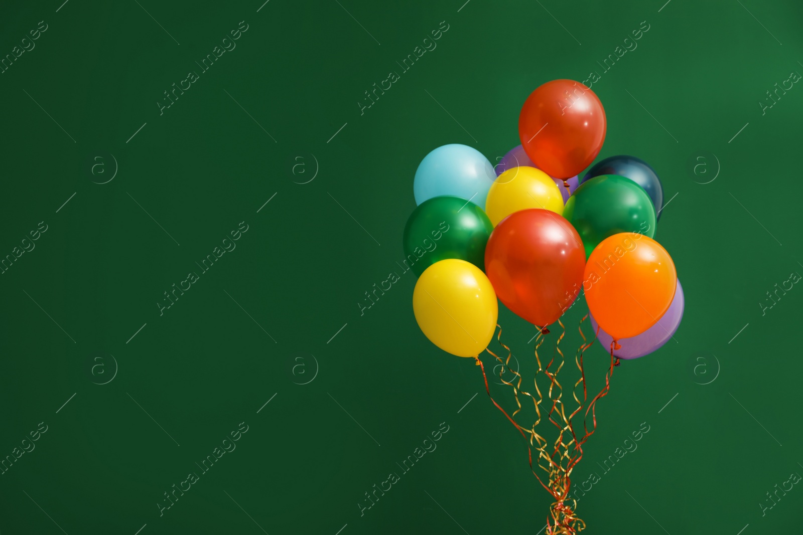 Photo of Bunch of bright balloons on color background, space for text. Celebration time