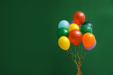 Bunch of bright balloons on color background, space for text. Celebration time