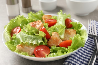 Photo of Delicious salad with chicken and cherry tomato on table, closeup