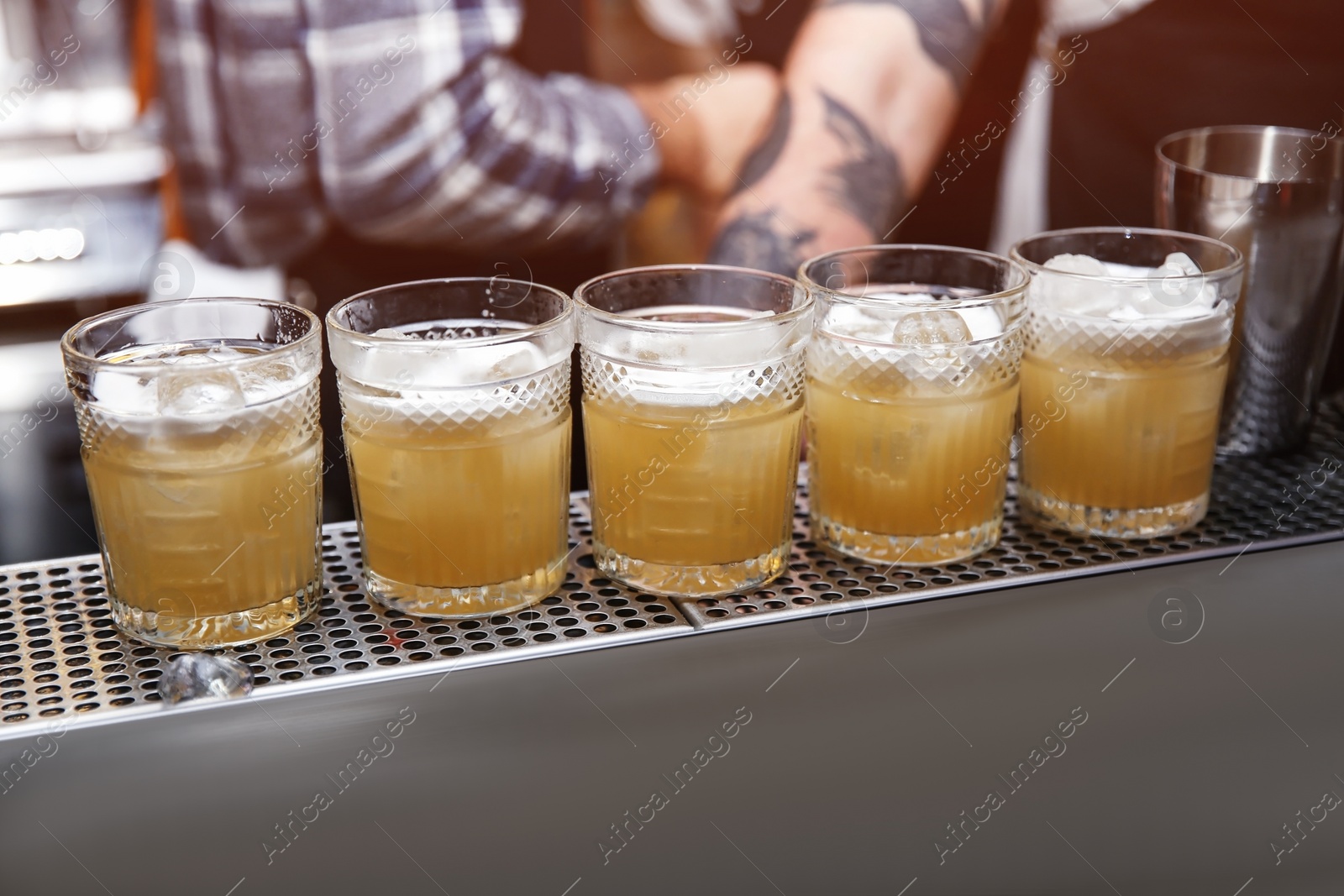 Photo of Glasses of tasty cocktail on bar counter