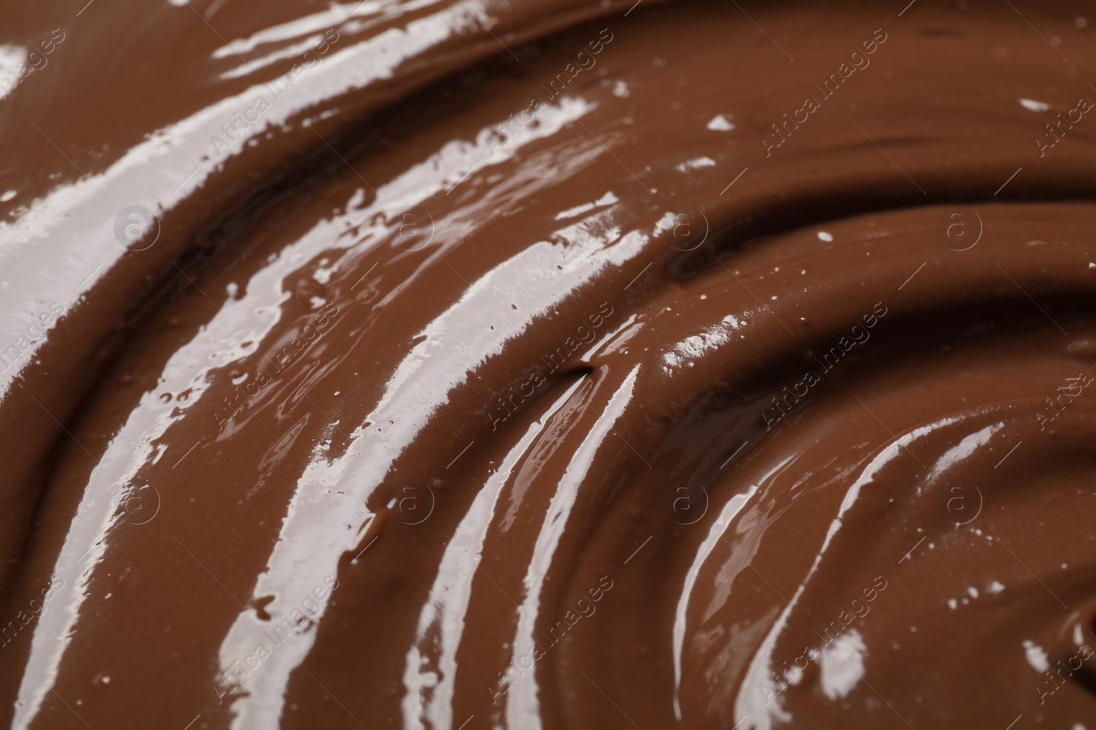 Photo of Tasty milk chocolate paste as background, closeup