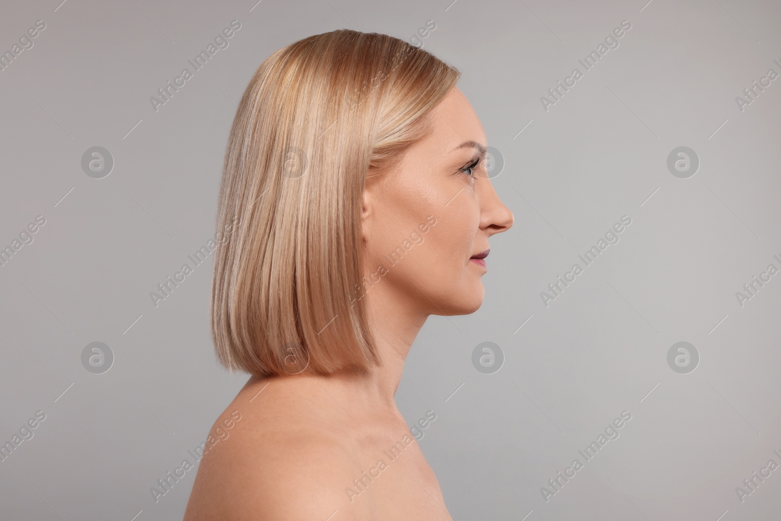 Photo of Beautiful woman with healthy skin on grey background