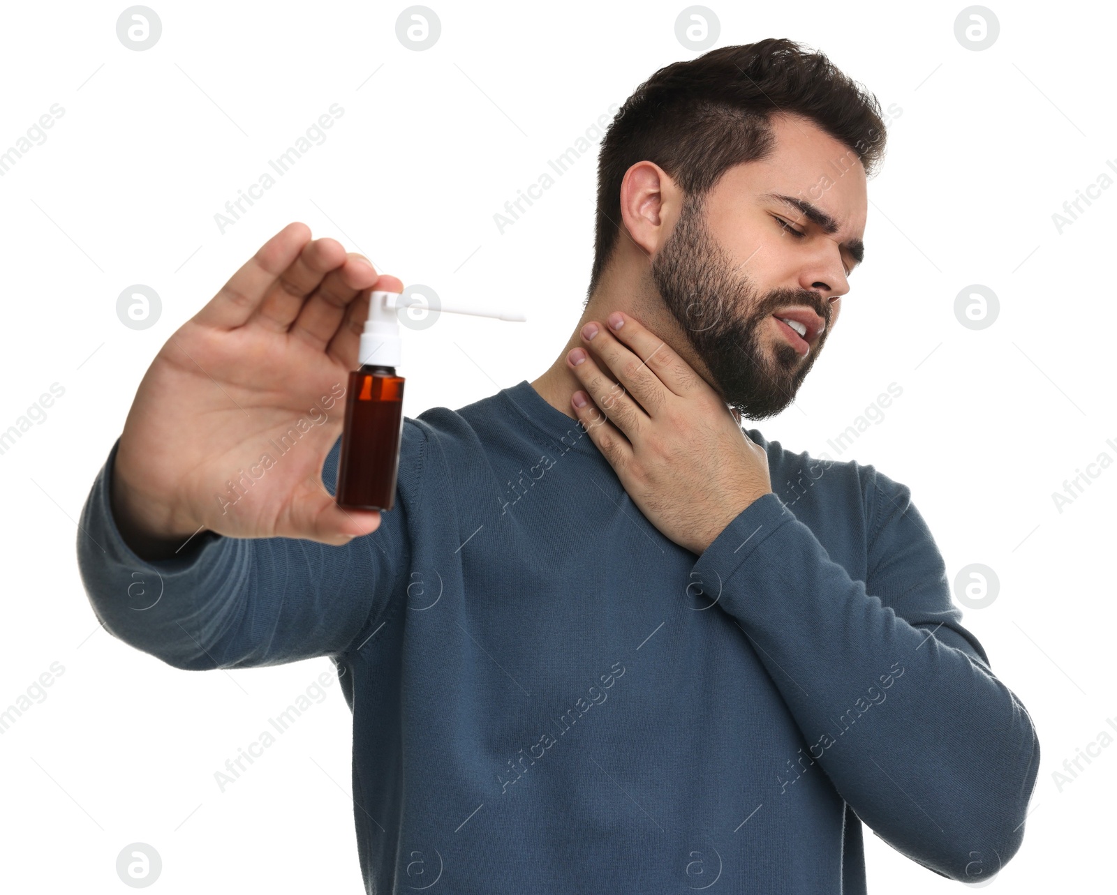 Photo of Young man holding throat spray on white background