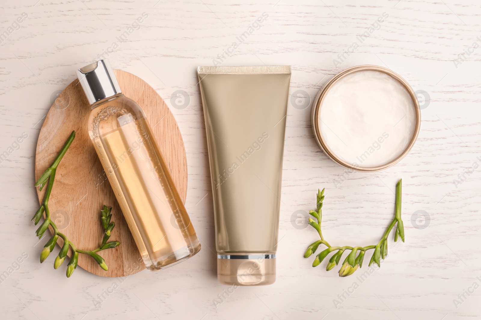 Photo of Flat lay composition with cosmetic products on white wooden table