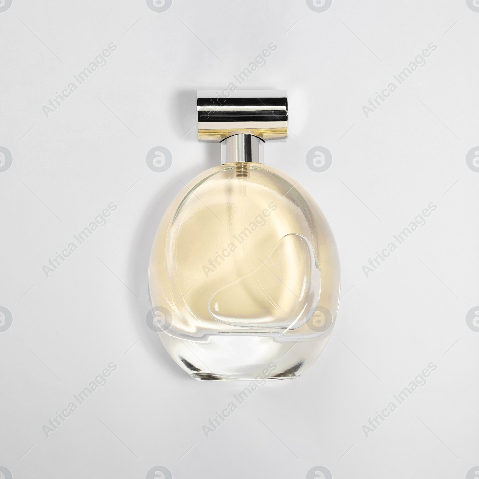 Photo of Luxury women's perfume in bottle on white background, top view