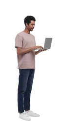 Smiling man using laptop on white background