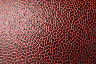 Photo of Leather American football ball as background, closeup