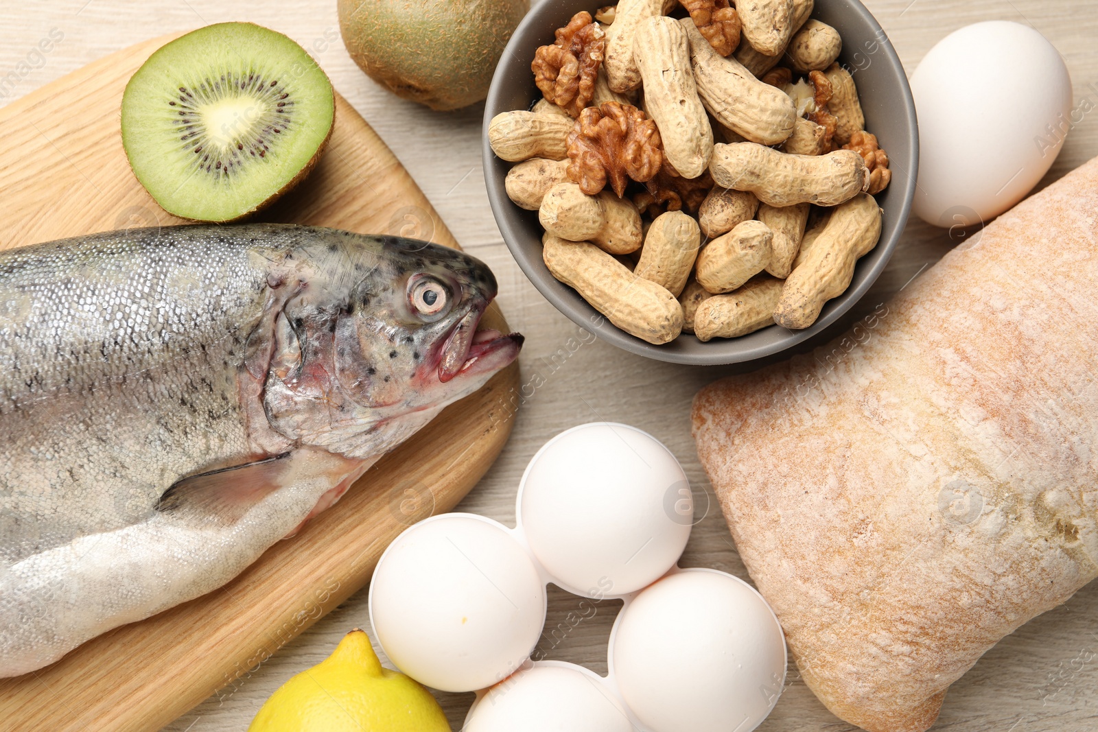 Photo of Allergenic food. Different fresh products on wooden table, flat lay